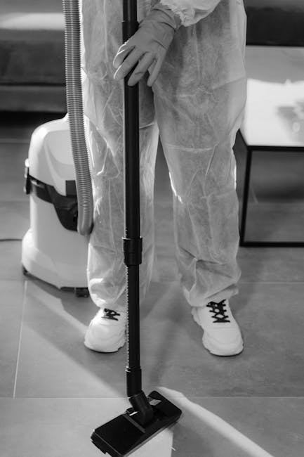 Three professional cleaners from westkensingtoncarpetcleaners.org.uk are performing surface cleaning and deep cleaning in a modern living room to ensure sanitisation and hygiene. The scene shows them 